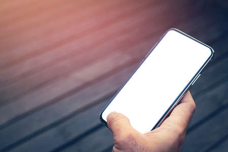 Close up of men hands holding touching mobile phone with blank copy space for your text message in...