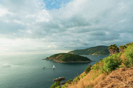 Beautiful blue sea, tourist boat on the island, Sky is cloudy with the light brightness of sunset at Promthep Cape, Phuket, landmark viewpoint, top view with Yacht and the miraculous sea of natureの写真素材