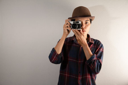 Asian photographer using Camera film RF or Rang Finder takes a photo. people and vintage object  Collectibles conceptの写真素材