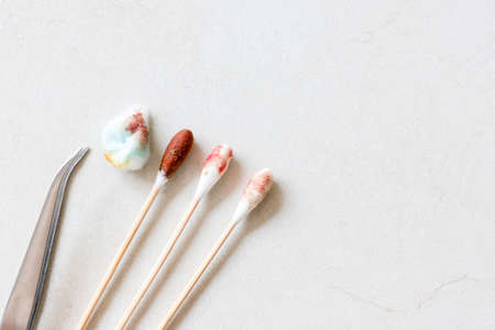 Stainless steel tweezers with cotton  Antiseptic, Blood from the accident. Medical detergent, first aid. Copy space for your text.の写真素材