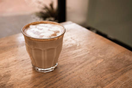 Hot coffee cup of latte art, coffee on wooden table in the morning. Soft focusの写真素材