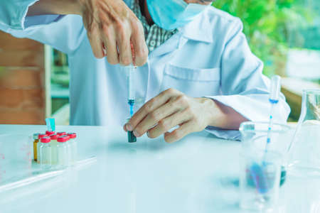 Not safety,  Medical science or male in laboratory room researcher performs tests of using Syringe...