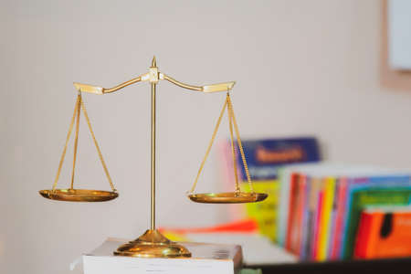 Legal scale on desk with a book backgroundの写真素材