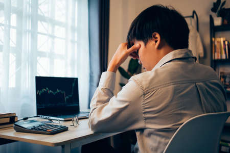 working hard businessmen or LGBTQ Asian people stress looking stock down of graphs cryptocurrency...