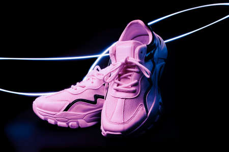 pink fashion the shoes accessory foot. and moving colorful lighting on black background, lifestyle...