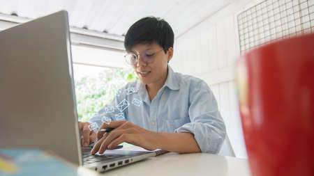 newsletter concept,  smiling asian businessman checking message box on digital laptop Vintage tone...