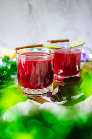 Beetroot and pineapple smoothie in glasess for dinner, party, celebrate or Christmas new year healthy drink. vertical photoの写真素材
