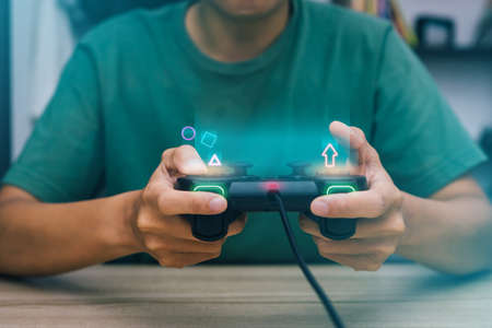 Close up hand playing  game using joystick console a games gadget video games.