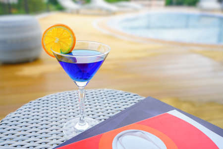 A refreshing blueberry soda fruit drink with some orange on top of the glass. vacation drink Relax by the rooftop pool at one of the hotels in Thailand.の写真素材