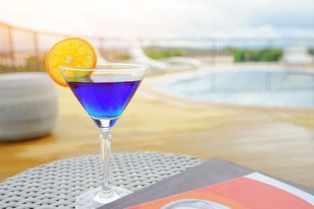 A refreshing blueberry soda fruit drink with some orange on top of the glass. vacation drink Relax by the rooftop pool at one of the hotels in Thailand.の写真素材