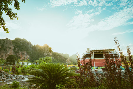 classic pink sleeping car is parked on street with beautiful surrounding mountains in the evening light sunset Accommodation, attractions in Thailand.の写真素材