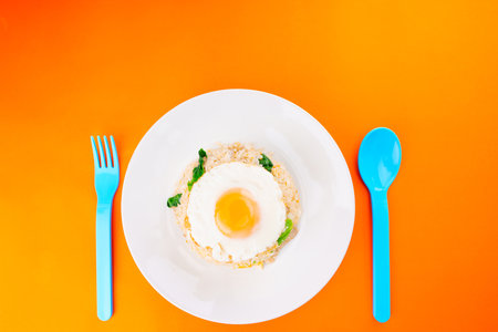 Thai food delicious homemade Fried rice with pork and kale Above is a fried egg on a white plate and...