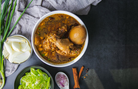 Thai food chicken drumsticks stewed in the herbs gravy and egg with chili,  onion, red onion, and...