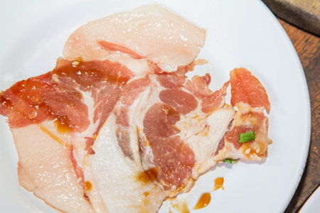 pork sesame seed curly parsley topped Ingredients and raw materials eating shabu, Sukiyaki, and pork on a white plate.の写真素材