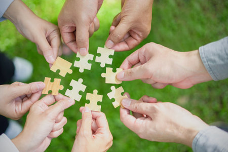 business hands holding jigsaw puzzle With the cooperation of business people team joins together to campaign Environment, Society and Corporate Governance. Sustainable corporate social, environmentalの写真素材