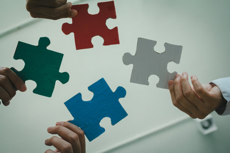 successful business team collaborates to solve challenges, symbolized by completing the final piece...