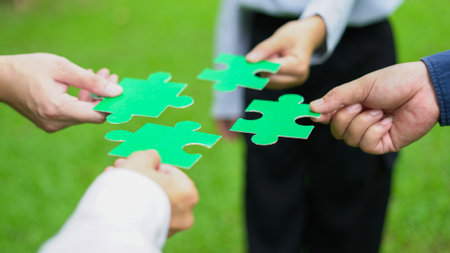 Hands join to piece together a sustainable future with teamwork, green solutions and business strategies for better tomorrow.の写真素材