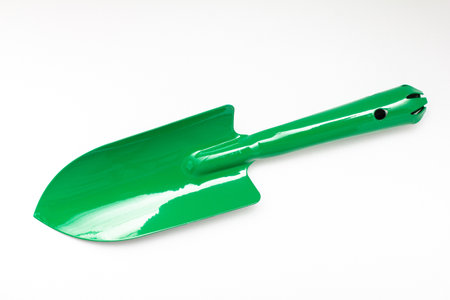 Green shovel small agricultural equipment, tilling soil, object on white backgroundの写真素材