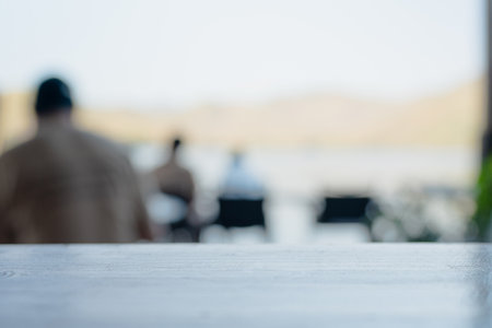 Selective focus blur of empty table for use. with People dining in a restaurant, abstract...