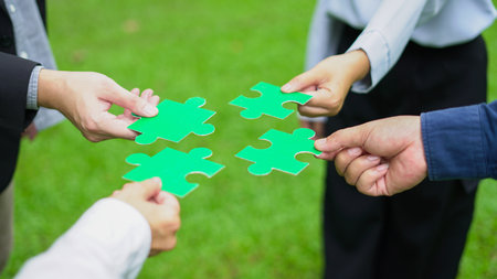 Teamwork Coworker's hand holding jigsaw puzzle With the cooperation of business people join together to campaign Environment concept, Copy space for your text.の写真素材