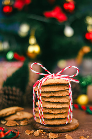 Handmade cookies wrapped with festive rope, capturing the spirit of Christmas and New Year  perfect as heartfelt gift in cozy vertical holiday photo concept.の写真素材