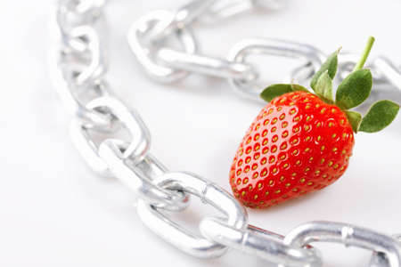 Strawberry laying on a white background among a chainの写真素材