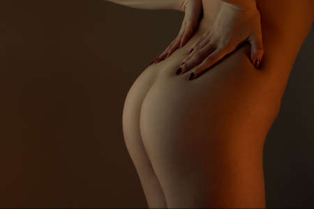 The young girl keeps the hands for a bottom of a backの写真素材