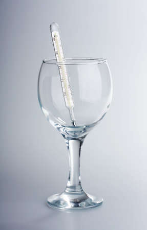 The thermometer in a glass glass on a white backgroundの写真素材