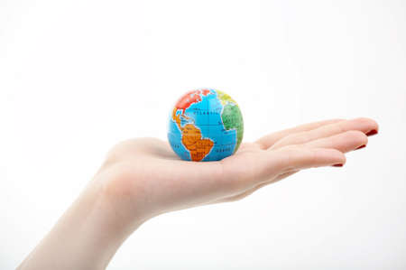 The globe in a hand on a white backgroundの写真素材