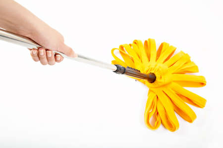 The hand holds a mop during cleaning on a white background の写真素材