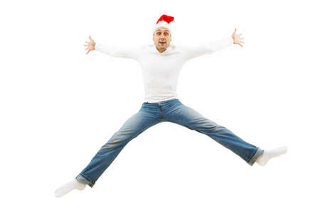 The fun man in a cap of the Christmas man is in a jump isolatedの写真素材