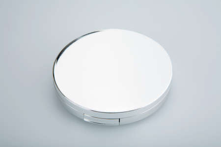 Closed cosmetic mirror on a white backgroundの写真素材