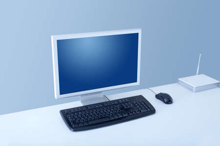 The monitor, the keyboard and the mouse on a white table