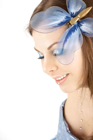 Portrait of the beautiful woman with a blue make-up and the butterfly in hair
の写真素材