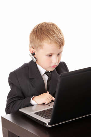 Little boy in a business suit with the computer, isolatedの写真素材