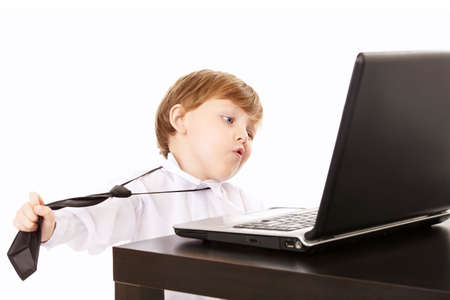 Llittle boy tries to remove a tie in an impulse of disgust for the work, isolated
の写真素材