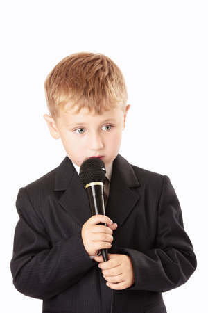Little boy sings something with a microphone in a hand, isolatedの写真素材