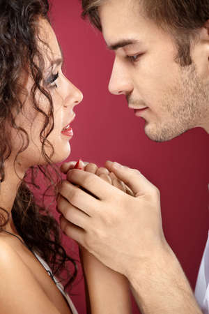 Close up - passionate look enamoured on a red backgroundの写真素材