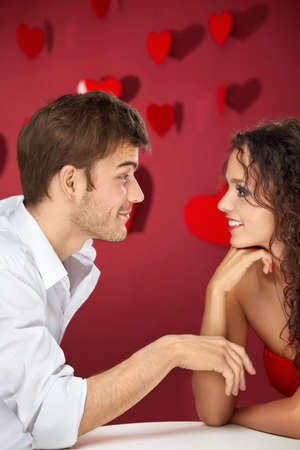 Conversation of two flirting enamoured on a red backgroundの写真素材
