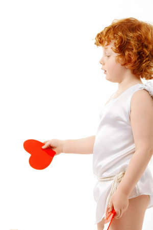 Profile of the small cupid with heart in a hand, isolated on a white backgroundの写真素材