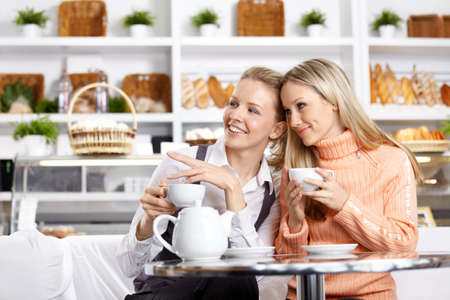 Two beautiful girls discuss something in cafe
の写真素材