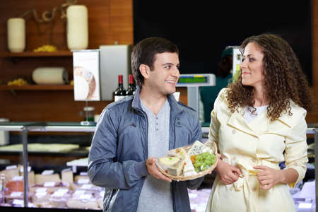 Married couple with cakes at a show-window in shop
の写真素材