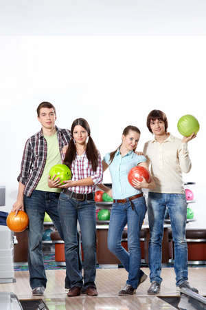 Young attractive people with spheres in bowlingの写真素材
