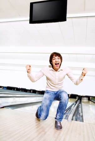 The young man rejoices to a successful throw in bowlingの写真素材