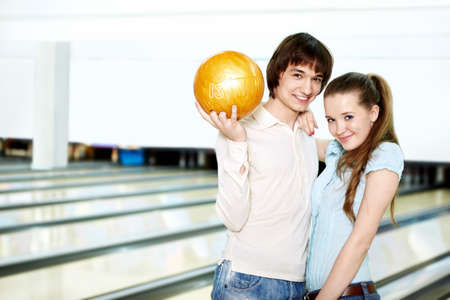 Young couple with a sphere for bowlingの写真素材