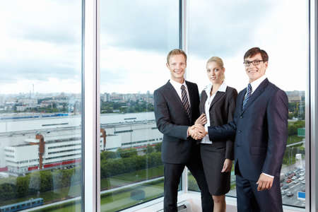 Business people in the background of a large windowの写真素材