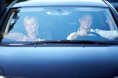 Young happy couple in the car