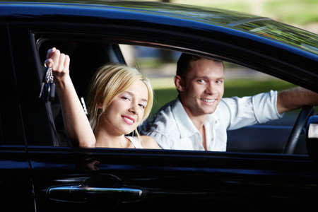 The happy couple with the keys in the car