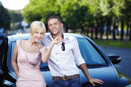 Young couple with the keys in carの写真素材