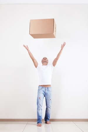A young man throws up a box